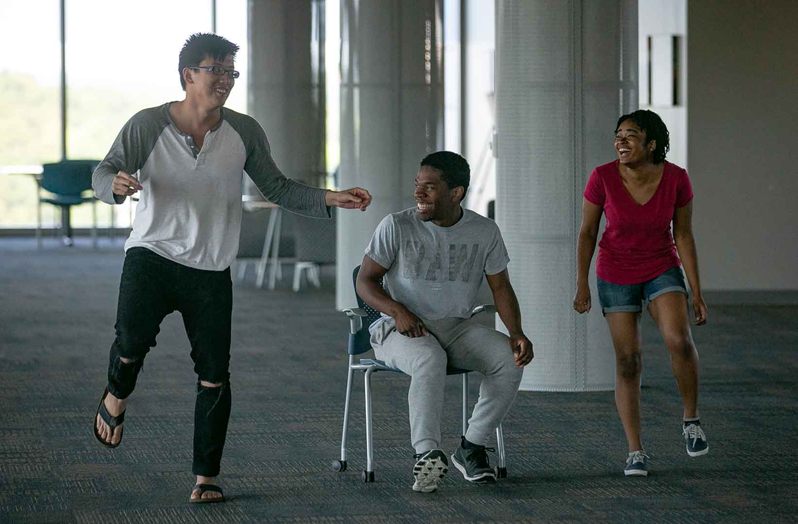 Three students perform as part of an exercise on music and healing.